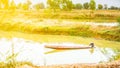 Man on a longtail boat with a cultivated land background Royalty Free Stock Photo