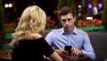 Man looking with annoyance on girlfriend who stopping him surfing net, addiction Royalty Free Stock Photo