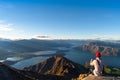 A man looking at the beautiful landscape of the mountains and Lake Wanaka. Roys Peak Track, South Island, New Zealand. I