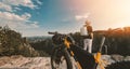 Man looking at beautiful misty mountains Enjoy panoramic mountain views. with bicycles ready to ride