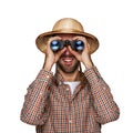 Man looking binoculars with traveler hat isolated over white background.