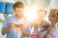 Man looking on boarding pass while his wife is carrying their daughter in airport Royalty Free Stock Photo