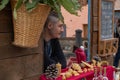 Man looking bored at a market stall at a craft market in Italy