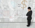 Man looking at business concept doodles on wooden wall Royalty Free Stock Photo