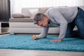 Man Looking At Carpet Through Magnifying Glass Royalty Free Stock Photo