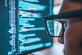 Man is looking at a computer screen with a lot of code on it Royalty Free Stock Photo