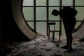 Man looking down at the papers in an abandoned church