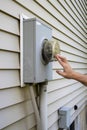 Man looking at electricity meter at home. Electric power box meter for home use, utility bill Royalty Free Stock Photo