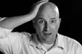 Man Looking Exasperated While Clutch His Head With His Hand in Black and White