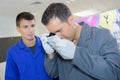 Man looking through eyepiece apprentice watching Royalty Free Stock Photo