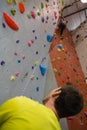 Man looking at female athlete climbing wall in club Royalty Free Stock Photo