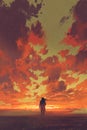 Man looking at fiery sunset sky