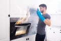 Man Looking At Fire Coming Out From Oven