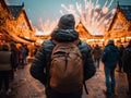 Man looking fireworks in a snowy christmas market and Enjoying of a charming holidays at night