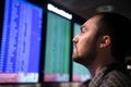 Man is looking at flight arrivals and departures board at airport Royalty Free Stock Photo