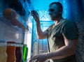 Man looking in a fridge for something to snack on Royalty Free Stock Photo