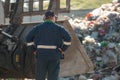 Man looking at garbage at landfill Royalty Free Stock Photo
