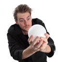 Man looking into a glass ball Royalty Free Stock Photo