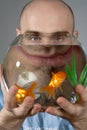 Man Looking Through Goldfish Bowl