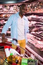 Man looking at goods in grocery section while shopping in supermarket Royalty Free Stock Photo