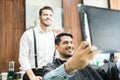 Man Looking At His New Haircut In Mirror At Barber Shop Royalty Free Stock Photo