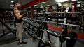 Man looking at his reflection mirror while doing dumbbell lift-ups, discipline Royalty Free Stock Photo