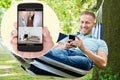Man Looking At Home Security System On Mobilephone