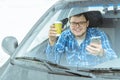 Man looking info in phone while sitting in car Royalty Free Stock Photo