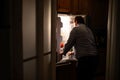 A man is looking inside an open refrigerator. Ai generated. Royalty Free Stock Photo