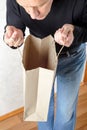 Man Looking Inside a Paper Bag Royalty Free Stock Photo