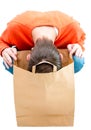 Man looking inside paper bag. Royalty Free Stock Photo