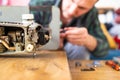 Man is looking inside sewing machine trying to repair it, hands closeup. Royalty Free Stock Photo