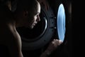 Man looking inside washing machine Royalty Free Stock Photo