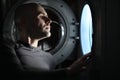 Man looking inside washing machine Royalty Free Stock Photo