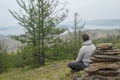Man looking at lake Baikal from top of the hillock