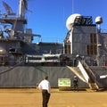 Man looking at large navy ship in Wellington harbour