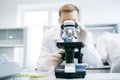 Man looking at microscope in laboratory Royalty Free Stock Photo