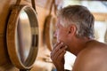 Man looking at mirror in cottage Royalty Free Stock Photo