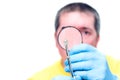 Man looking at mite through magnifier, on white background