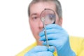 Man looking at mite through magnifier, on white background