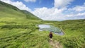 Man looking on mountain lake at Dragobrat, Carpathian mountains