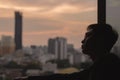 The man looking out at city view from the room. Royalty Free Stock Photo