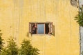 Man looking out the window waving hand in New Delhi. India