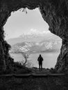 A man looking outside a cave in black and white Royalty Free Stock Photo