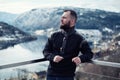 Man looking over Hardangerfjord from house terrace, Norway.