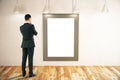 Man looking at picture frame Royalty Free Stock Photo