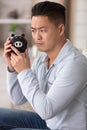 man looking at piggy bank suspiciously Royalty Free Stock Photo