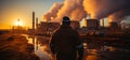 Man is looking at power plant at sunset Royalty Free Stock Photo