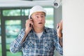 Man looking at security camera and making phonecall Royalty Free Stock Photo