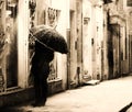 Man looking in a shop window in the snowy night